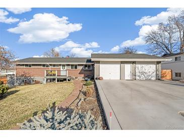 Charming home featuring a two-car garage, brick accents, and a welcoming front deck at 3700 Miller St, Wheat Ridge, CO 80033