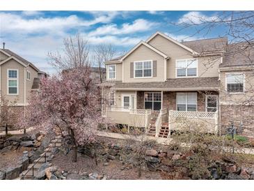 Charming multi-level home with a stone and siding facade, landscaped front yard, and inviting front porch at 326 W Jamison Pl # 51, Littleton, CO 80120