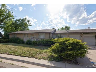 Charming single-story brick home with a well-manicured front yard and a covered front porch at 6579 S Lincoln St, Centennial, CO 80121
