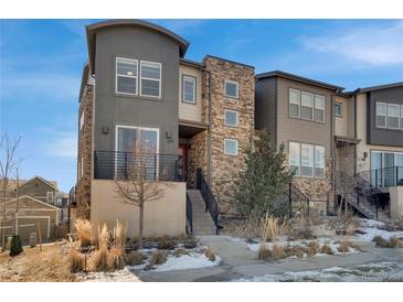 Striking multi-level home featuring modern architecture, stone accents, balcony and well-maintained landscaping at 2602 Meadows Blvd # A, Castle Rock, CO 80109