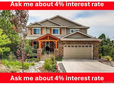 Charming two-story home with a well-manicured front yard and a welcoming covered porch at 1970 Woodbourne Ter, Castle Rock, CO 80104