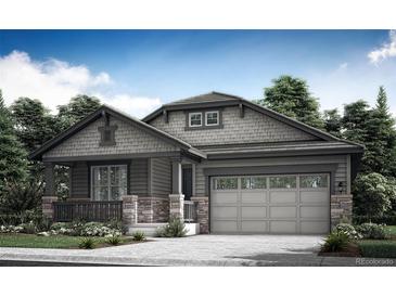 Charming single-story home with stone accents and a two-car garage at 12760 W Glasgow Pl, Littleton, CO 80127