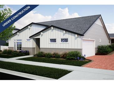 Under construction charming single-story home with white siding, gray accents, attached garage, and manicured lawn at 21917 E 51St Dr, Aurora, CO 80019
