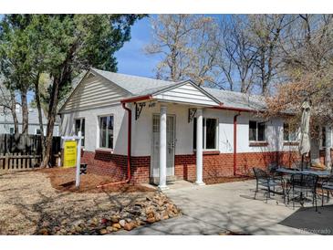 Charming single-story home featuring brick accents, white trim and inviting front patio at 4078 Ames St, Wheat Ridge, CO 80212