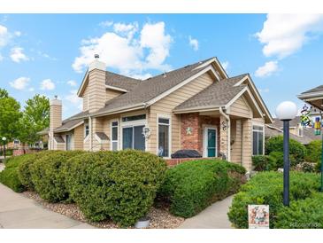 Charming, well-maintained home with mature landscaping and inviting curb appeal on a sunny day at 2164 S Troy Way, Aurora, CO 80014
