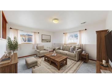 Cozy living room with neutral tones, large area rug, and comfortable seating arrangements at 412 N 10Th Ave, Brighton, CO 80601