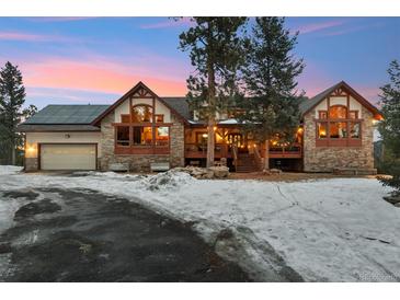 Stunning two-story home with stone exterior and mountain views at 10120 Apache Spring Dr, Conifer, CO 80433