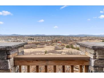 Expansive view from the porch showcasing the neighborhood and mountain ranges in the distance at 1995 Wingfeather Ln, Castle Rock, CO 80108