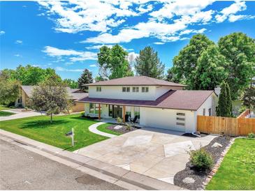 Beautiful two-story home featuring a well-manicured lawn and an ample driveway at 6716 W Rowland Ave, Littleton, CO 80128