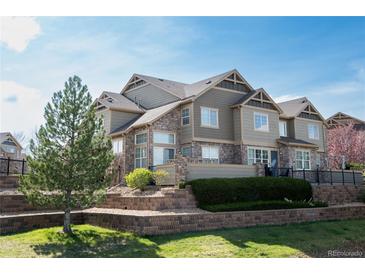 Attractive townhome with stone accents, neat landscaping, and inviting curb appeal in a desirable community at 5732 S Addison Way # E, Aurora, CO 80016