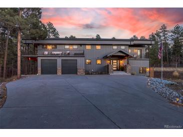 Stunning two-story home with large windows and attached three-car garage at 1580 Crystal Way, Franktown, CO 80116