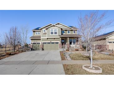 Charming two-story home showcasing a well-maintained lawn, three-car garage, and classic architectural details at 7899 S Country Club Pkwy, Aurora, CO 80016