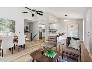 Bright living room with modern decor, hardwood floors, and a ceiling fan at 19644 E Girard Dr, Aurora, CO 80013