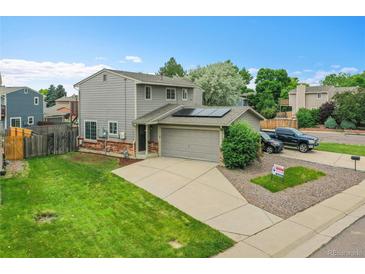 Well maintained two-story home with an attached two-car garage and solar panels at 12651 Elm St, Thornton, CO 80241