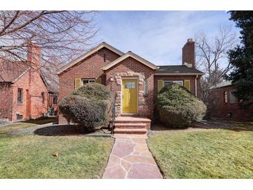 Charming brick home with a landscaped front yard and welcoming yellow front door at 1280 Fairfax St, Denver, CO 80220