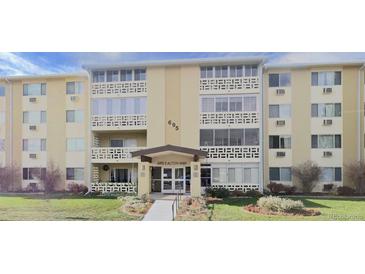 A light yellow apartment complex with well-maintained landscaping and ample natural light at 695 S Alton Way # 6B, Denver, CO 80247