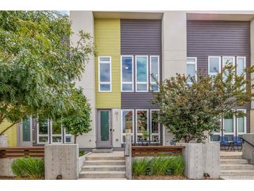Modern townhome showcasing vibrant architecture, lush landscaping, and inviting outdoor seating area at 2824 W Parkside Pl, Denver, CO 80221