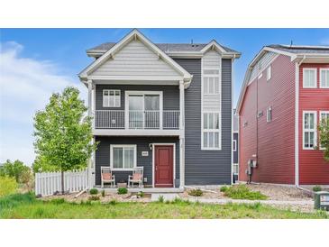 Charming two-story home with a cozy front porch and a well-manicured lawn at 18645 E 54Th Pl, Denver, CO 80249