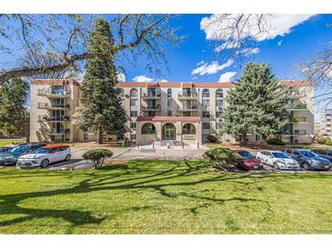 Inviting condo building with well-maintained lawns, lush trees, and ample parking for residents and guests at 7801 W 35Th Ave # 406, Wheat Ridge, CO 80033