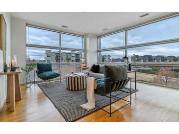 Spacious living room with large windows and city views at 2958 Syracuse St # 303, Denver, CO 80238