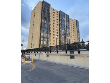Modern high-rise condominium featuring multiple floors of units with large windows and secure resident access at 7865 E Mississippi Ave # 706, Denver, CO 80247