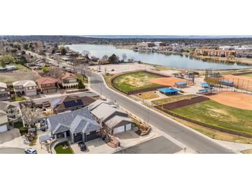 Stunning aerial view showcasing the property's proximity to the lake, baseball fields, and neighborhood amenities at 6595 Meade Ct, Arvada, CO 80003
