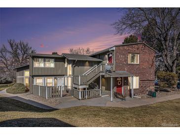 Charming multi-Gathering home with brick accents and well-maintained landscaping at dusk at 857 S Van Gordon Ct # G208, Lakewood, CO 80228