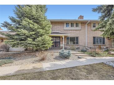 Charming brick townhouse with a well-manicured yard and inviting front entrance at 3310 S Oneida Way, Denver, CO 80224