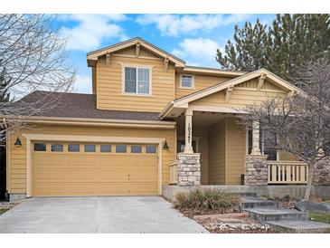 Two-story Craftsman home with a neutral color palette and attached garage at 10247 Telluride Way, Commerce City, CO 80022