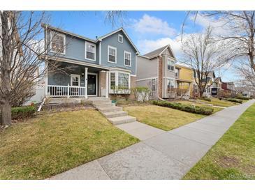 Charming two-story home featuring a covered front porch and well-manicured lawn at 7860 E Ellsworth Ave, Denver, CO 80230