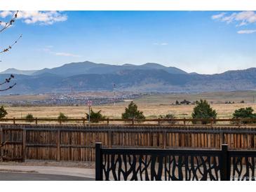 Expansive backyard view showcasing open space and mountain views in the distance at 11551 W 103Rd Dr, Broomfield, CO 80021