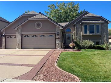 Charming home featuring a well-manicured lawn and a two-car garage at 6833 S Miller St, Littleton, CO 80127