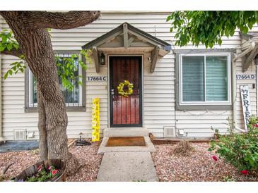 Charming townhome with a decorative wreath on the front door and a cheerful welcome sign at 17664 E Loyola Dr # C, Aurora, CO 80013