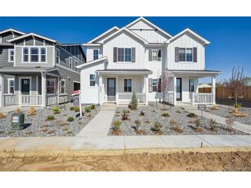 Charming new two-story home with a landscaped yard and inviting front porch at 1374 Penner Dr, Erie, CO 80026