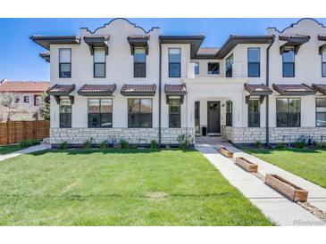 Inviting exterior of a multi-story home with a well-manicured lawn, stone accents, and attractive architectural details at 1640 Winona Ct, Denver, CO 80204