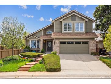 Charming two-story home boasts a well-manicured lawn and a welcoming facade with a two-car garage at 17038 Lamar Dr, Parker, CO 80134