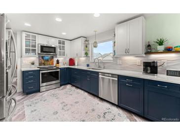 Bright kitchen features modern two-tone cabinets, stainless steel appliances, and stylish countertops at 2292 Brantner Pl, Brighton, CO 80601
