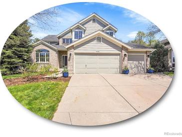 Charming two-story home with a well-manicured lawn and a spacious three car driveway at 10388 Lions Path, Lone Tree, CO 80124