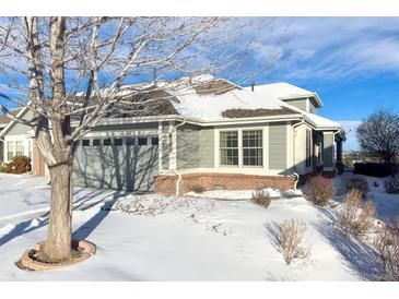 Charming ranch home with snow-covered yard and attached garage at 8182 S Winnipeg Ct, Aurora, CO 80016