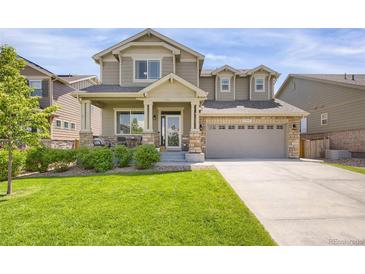 Charming two-story home with a well-manicured lawn and inviting front porch at 17052 Lipan St, Broomfield, CO 80023