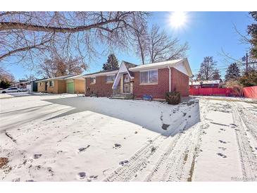 Brick ranch home with snow-covered yard at 12152 E Dakota Ave, Aurora, CO 80012