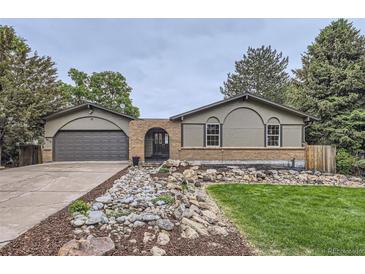 Charming home featuring unique brickwork, a well-manicured yard, and a two-car garage at 1010 Ash St, Broomfield, CO 80020