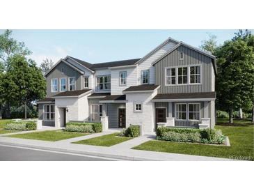 Attractive townhome featuring a blend of stone and siding, complemented by well-maintained landscaping at 6579 Parterre N Pkwy # 1, Thornton, CO 80602