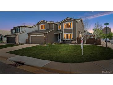 Charming two-story home with a well-manicured lawn and attached two-car garage at 6502 Shea Pl, Highlands Ranch, CO 80130