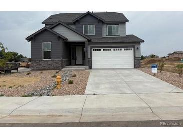 Beautiful two-story home with a two car garage and neutral gray paint at 1759 Jennifer St, Brighton, CO 80601