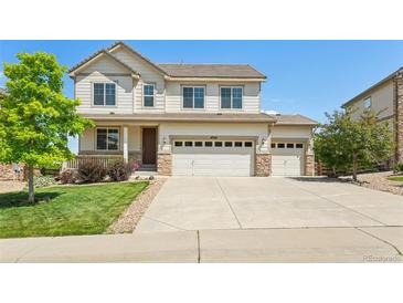 Inviting two-story home featuring a three car garage, manicured lawn, and charming front porch at 4920 S Netherland Way, Centennial, CO 80015