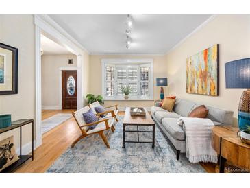 Cozy living room features hardwood floors, shutters, and a comfortable seating arrangement at 433 N Ogden St, Denver, CO 80218