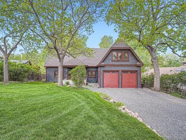 Inviting two-story home with a manicured lawn and a two-car red garage at 845 Urban St, Lakewood, CO 80401