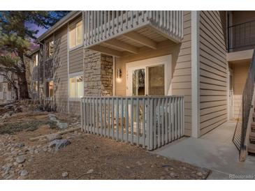 Cozy balcony featuring a seating area, stone accents, and a white railing for relaxing outdoors at 4400 S Quebec St # 107, Denver, CO 80237
