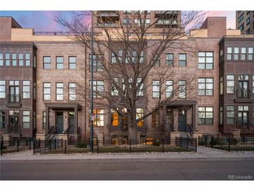 Attractive brick townhomes with well-manicured landscaping and secure black metal fencing at 1674 Fillmore St # Al3, Denver, CO 80206